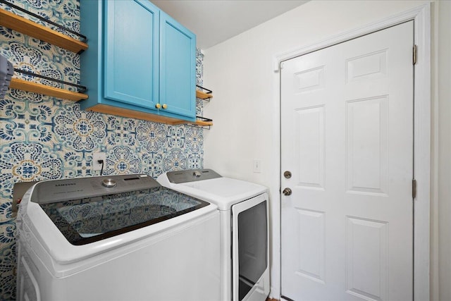 washroom with cabinet space and washing machine and dryer