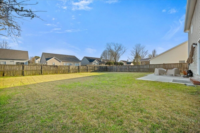 view of yard with a residential view, a patio area, and a fenced backyard