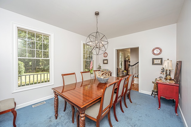 carpeted dining area with a notable chandelier