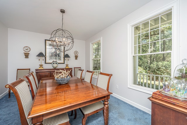 dining room featuring an inviting chandelier and dark carpet