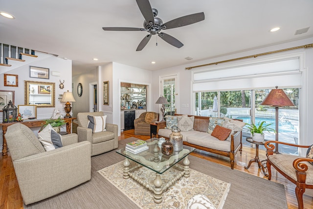 living room featuring ceiling fan and light hardwood / wood-style flooring