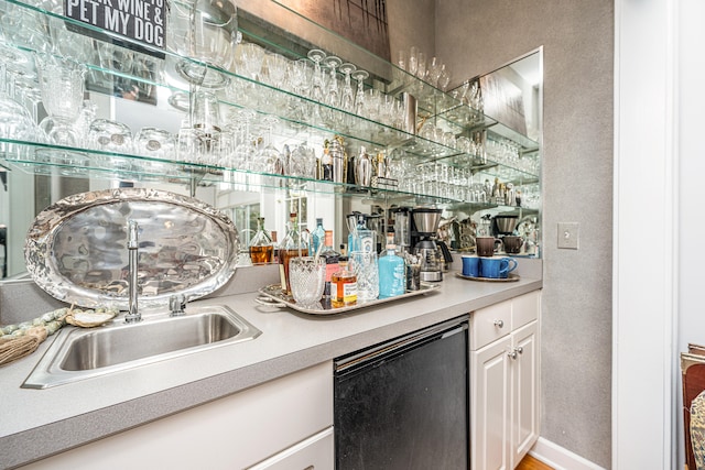 bar featuring white cabinets and dishwasher