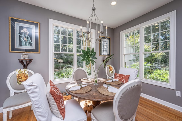 dining space with a notable chandelier and hardwood / wood-style flooring