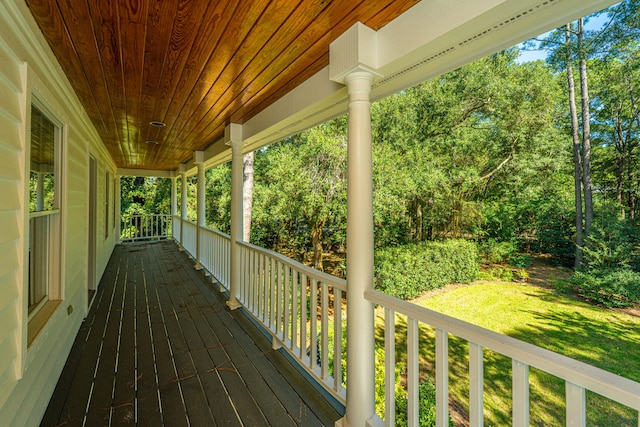 deck featuring a lawn and a porch