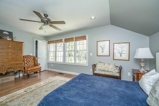 bedroom with ceiling fan, hardwood / wood-style flooring, and lofted ceiling