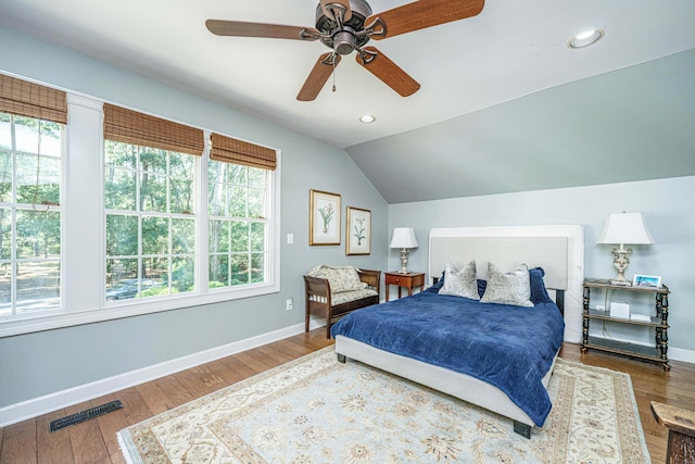 bedroom featuring ceiling fan, hardwood / wood-style flooring, and lofted ceiling