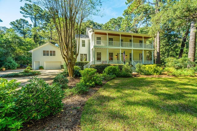 view of front of house featuring a balcony, a garage, a front yard, and a porch