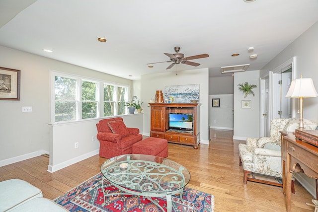 living room with light hardwood / wood-style floors and ceiling fan