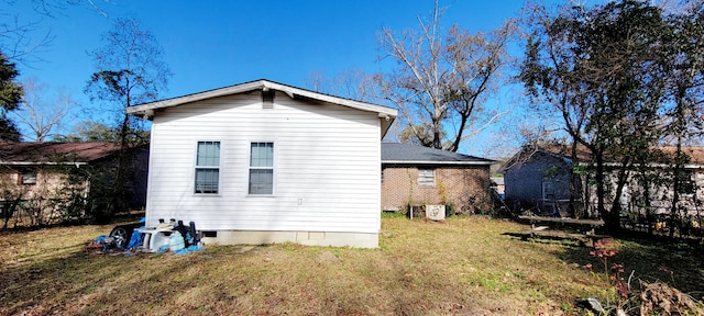 rear view of property with a lawn