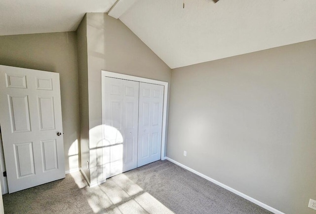 bedroom featuring light colored carpet, a closet, and lofted ceiling