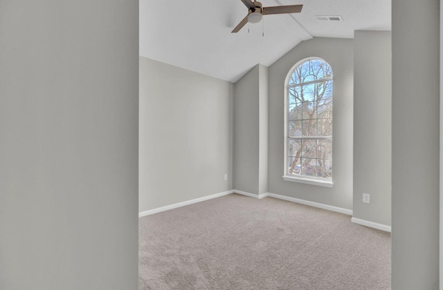 carpeted spare room with ceiling fan and lofted ceiling