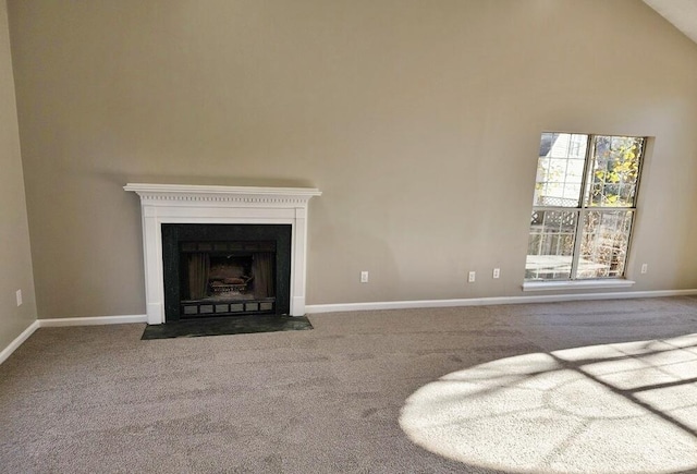 unfurnished living room featuring carpet flooring and high vaulted ceiling