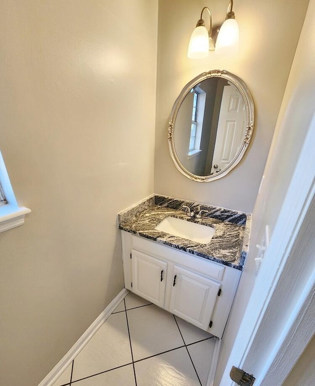 bathroom featuring tile patterned floors, vanity, and a chandelier