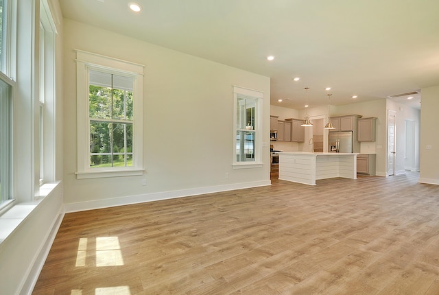 unfurnished living room featuring light wood-style floors, recessed lighting, and baseboards