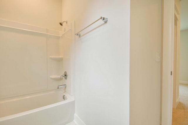 bathroom with baseboards and shower / tub combination