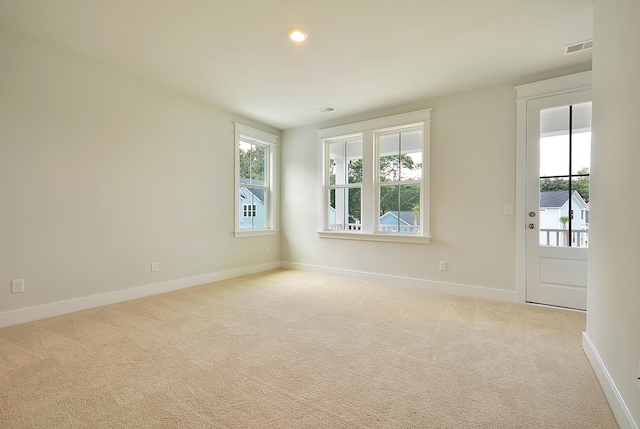carpeted empty room featuring recessed lighting, baseboards, and visible vents