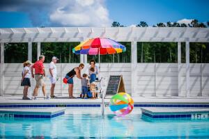 community pool featuring a pergola and a water play area
