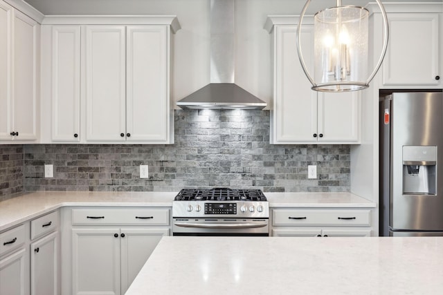 kitchen with stainless steel appliances, wall chimney exhaust hood, and light countertops