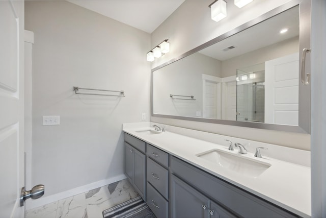 full bath with a stall shower, baseboards, marble look tiles, and double vanity