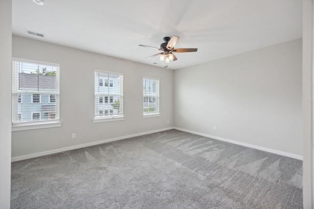 unfurnished room featuring a ceiling fan, carpet floors, and baseboards