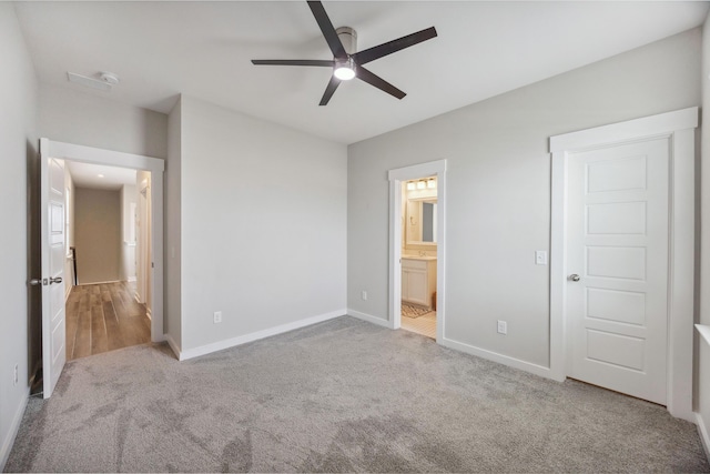 unfurnished bedroom with carpet, baseboards, connected bathroom, and ceiling fan
