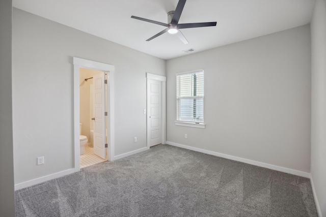unfurnished bedroom with carpet, baseboards, ensuite bath, and ceiling fan