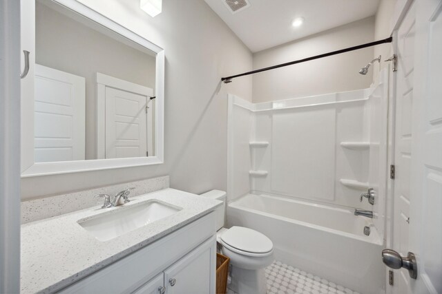 bathroom with toilet, vanity, and shower / washtub combination