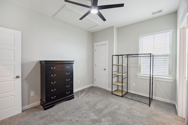 carpeted bedroom featuring attic access, multiple windows, baseboards, and ceiling fan