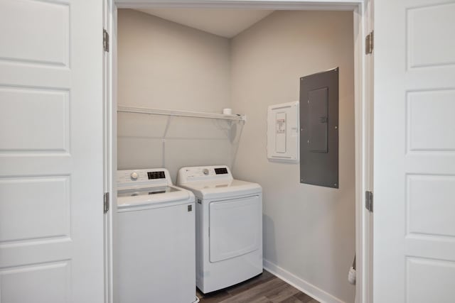 laundry area with washer and dryer, electric panel, dark wood-style flooring, and baseboards