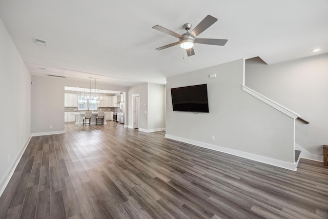 unfurnished living room featuring baseboards, ceiling fan, dark wood finished floors, stairway, and recessed lighting
