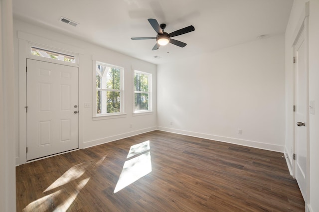 entrance foyer featuring dark wood-style floors, visible vents, a ceiling fan, and baseboards