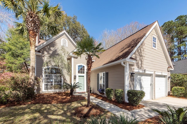 view of front of home featuring concrete driveway and a garage