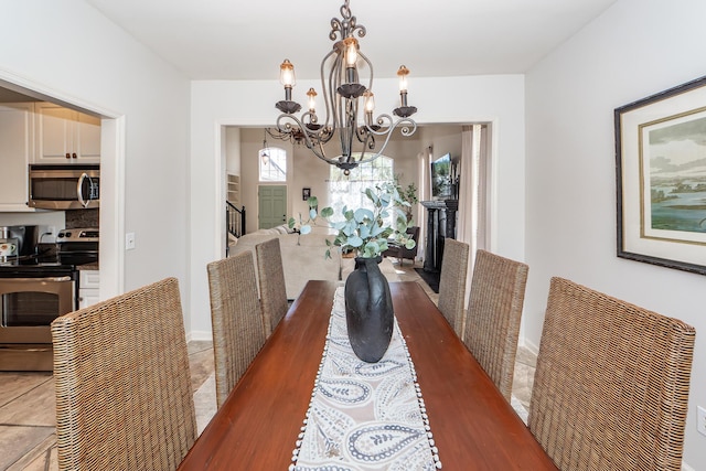 dining room with stairway, a chandelier, and tile patterned flooring