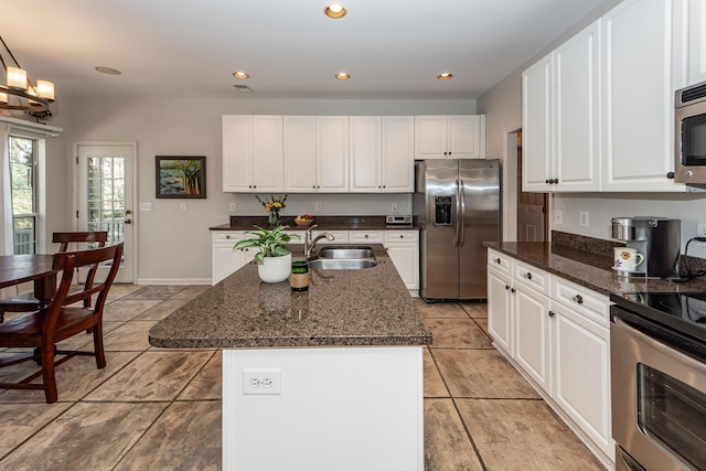 kitchen with recessed lighting, white cabinets, appliances with stainless steel finishes, and a sink