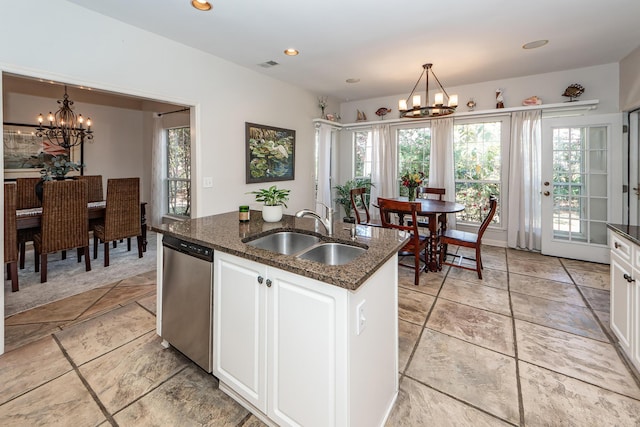 kitchen with a sink, plenty of natural light, stainless steel dishwasher, and an inviting chandelier