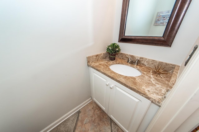 bathroom with vanity and baseboards