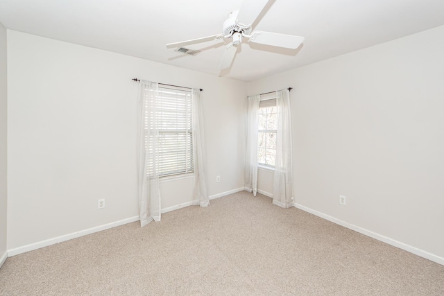 spare room with visible vents, baseboards, carpet, and ceiling fan