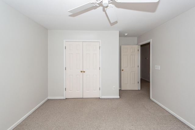 unfurnished bedroom with carpet flooring, baseboards, a closet, and ceiling fan