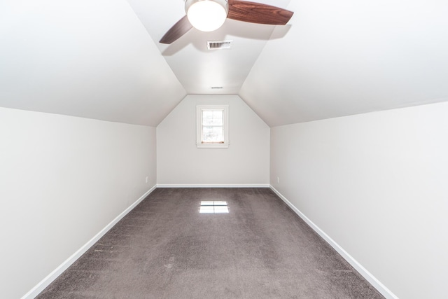 additional living space featuring visible vents, carpet floors, baseboards, and vaulted ceiling