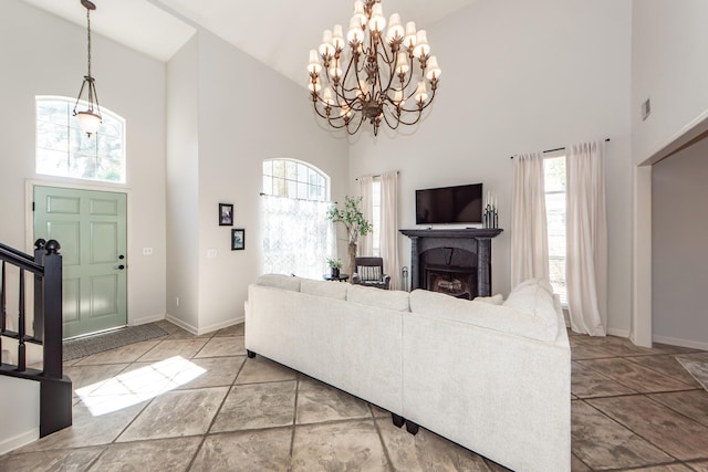 living area with stairway, a fireplace, baseboards, and high vaulted ceiling