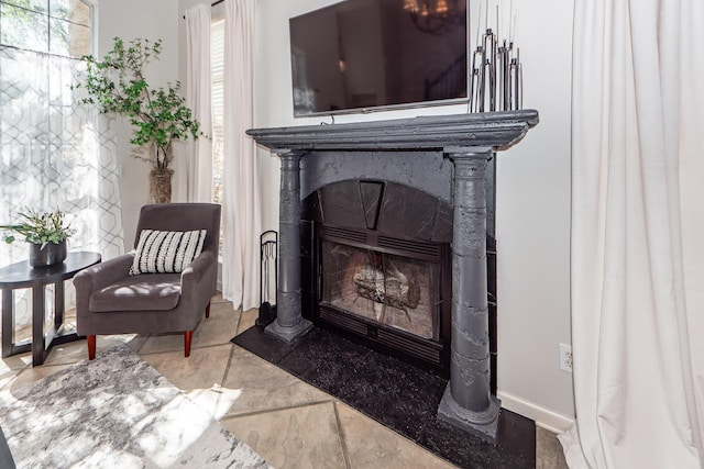 sitting room featuring a fireplace and baseboards