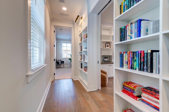 corridor with light hardwood / wood-style flooring