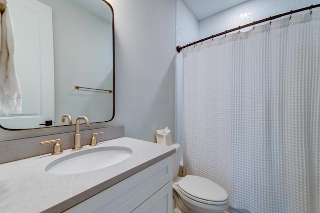 bathroom featuring vanity, curtained shower, and toilet