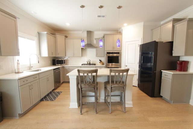 103 Granton Edge Ln, Summerville, SC 29486 - kitchen featuring stainless steel appliances, wall chimney range hood, a kitchen island, crown molding, and a kitchen breakfast bar