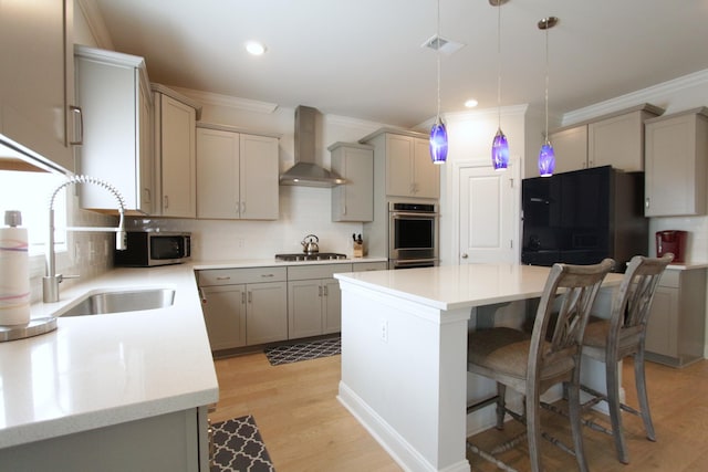 103 Granton Edge Ln, Summerville, SC 29486 - kitchen featuring wall chimney exhaust hood, appliances with stainless steel finishes, gray cabinets, ornamental molding, and a center island