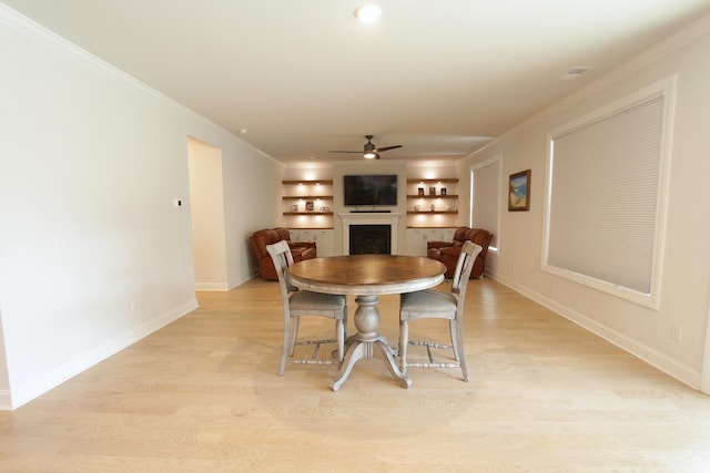 103 Granton Edge Ln, Summerville, SC 29486 - dining room with a ceiling fan, ornamental molding, a fireplace, light wood-style floors, and built in features