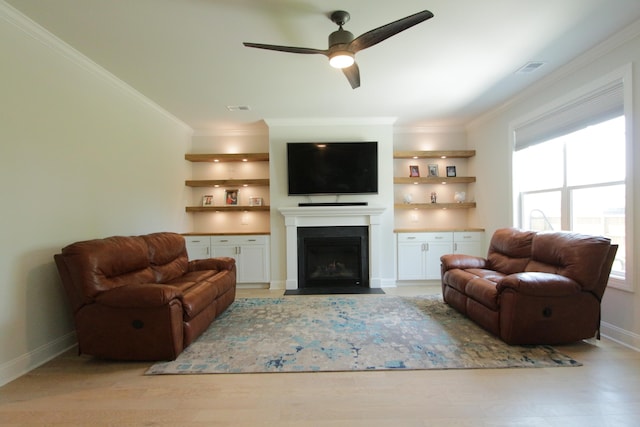 103 Granton Edge Ln, Summerville, SC 29486 - living room featuring ornamental molding, a ceiling fan, a fireplace with flush hearth, light wood-style flooring, and built in features