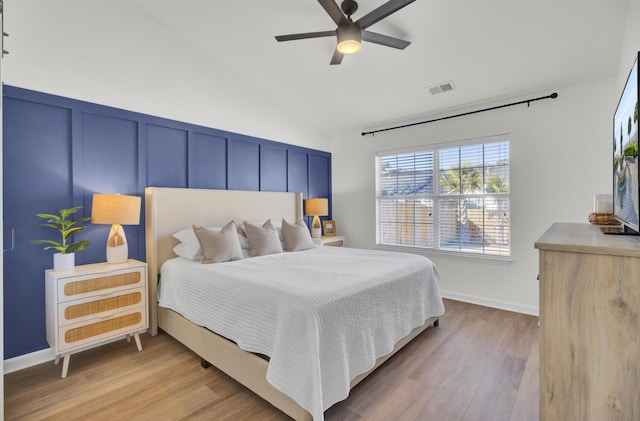 bedroom featuring light wood-type flooring, ceiling fan, and lofted ceiling