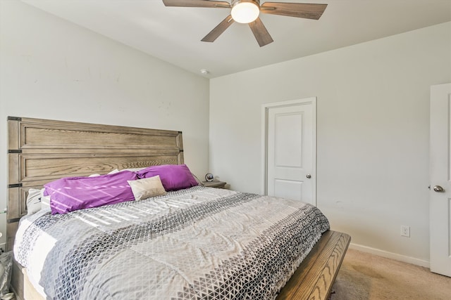 bedroom with a ceiling fan, baseboards, and light colored carpet