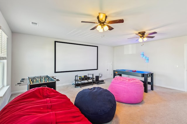 home theater with visible vents, carpet, and ceiling fan